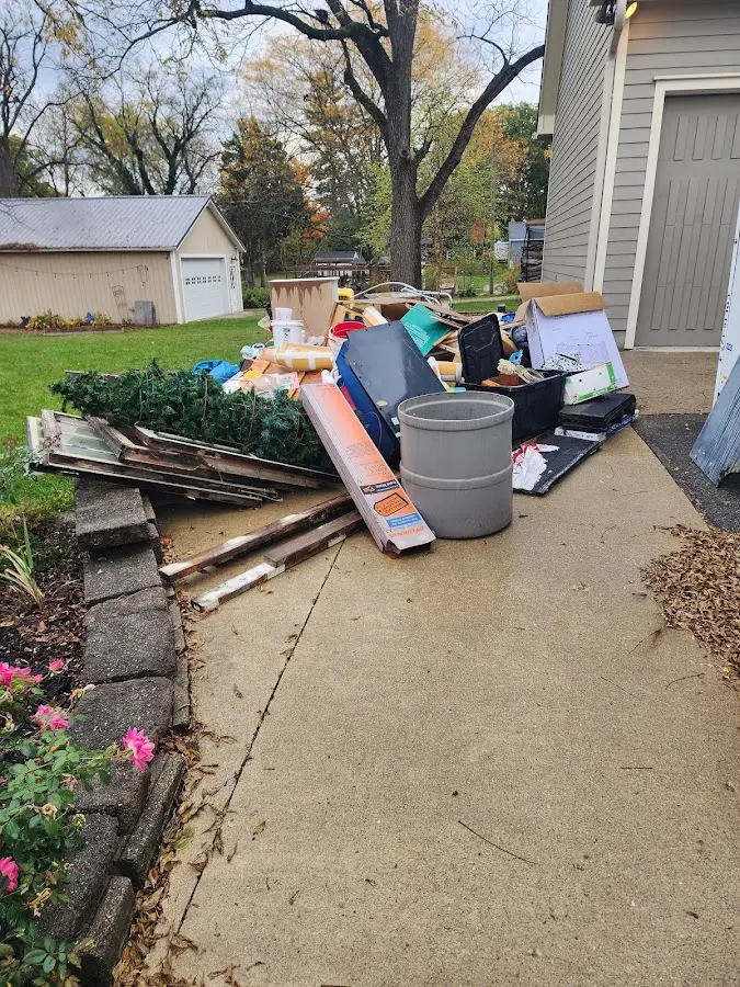Dumpster being loaded with debris for Estate Cleanout Dumpster Rental in San Diego Country Estates